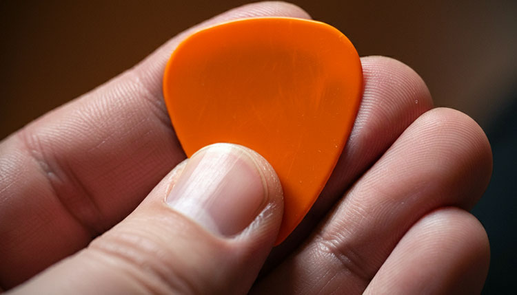 holding a guitar pick