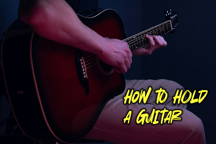 how to hold a guitar